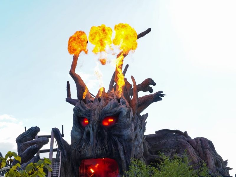 A fire-breathing monster tears out part of the track of the intense wooden roller coaster Colossos at the theme park Heide Park